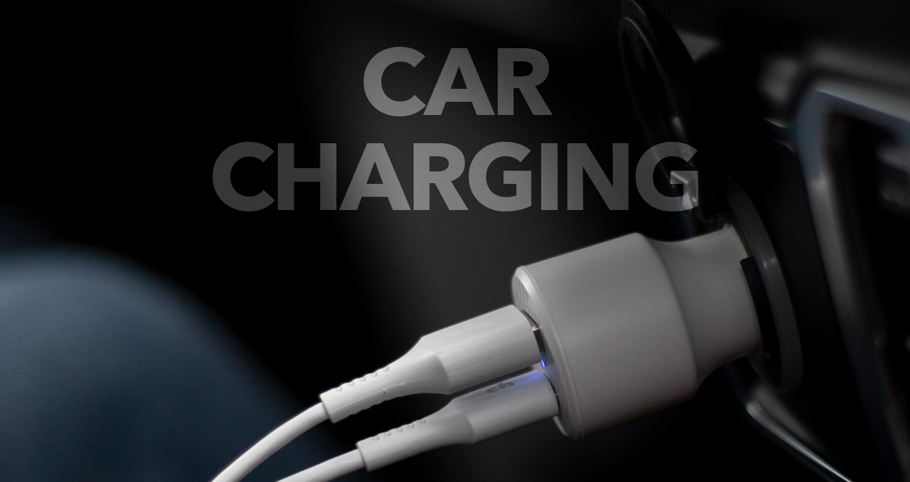 cables plugged into a cellphone car charger